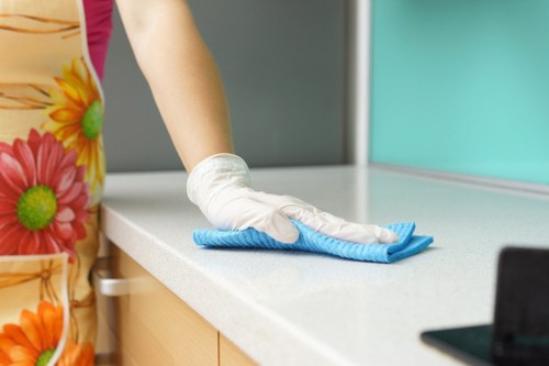 Cleaner using PPE during a cleaning task